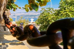a chain in front of a view of the water at Apartment Sidro in Postira