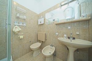 a bathroom with a sink and a toilet at Apartment Sidro in Postira