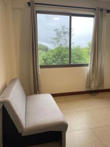 a room with a chair and a large window at 3-Bedroom Condo in a Golf Course in Santa Cruz de la Sierra