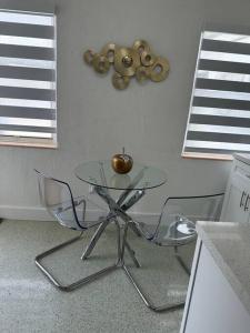 a glass table and two chairs in a kitchen at Villa Clara Gold-Little Havana in Miami