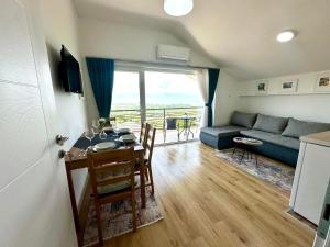a living room with a table and a couch at D&A Apartments in Ohrid