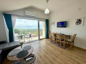 a living room with a table and a dining room at D&A Apartments in Ohrid