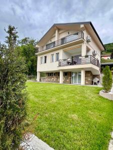 a large house with a lawn in front of it at D&A Apartments in Ohrid