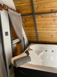 a bath tub in a room with a wooden wall at BİTEK BUNGALOV in Trabzon +25 photos