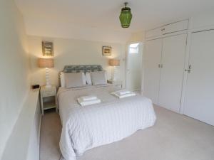 a bedroom with a bed with two towels on it at Priors Mead in Banbury