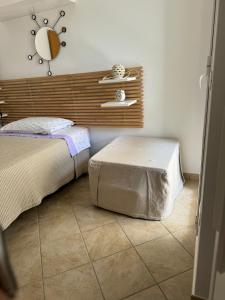 a bedroom with a bed and a mirror on the wall at HOLLY CASA VACANZE TORRE DELL'ORSO in Torre dell'Orso +25 photos