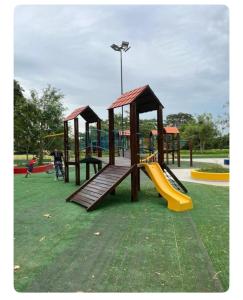 a park with a playground with slides and a slideintend at 3-Bedroom Condo in a Golf Course in Santa Cruz de la Sierra