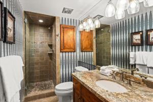 a bathroom with a sink and a toilet and a shower at Little Nell Condominiums Unit 11, Top Floor Condo with Mountain Views, 3 Blocks to Gondola in Aspen +11 photos