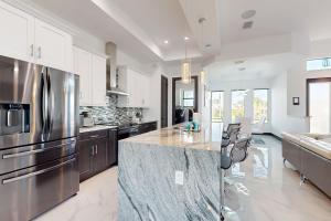 eine Küche mit Küchengeräten aus Edelstahl und eine große Insel in der Unterkunft Sunset Serenity in Cape Coral
