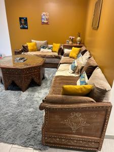 a living room with two couches and a table at Maison entière haut standing in Mignaloux-Beauvoir