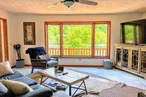a living room with a couch and a table at Lakefront Hideaway in Eureka Springs