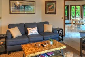 a living room with a blue couch and a table at Lakefront Hideaway in Eureka Springs