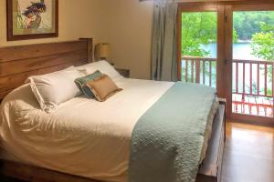 a bed with two pillows on it in a bedroom at Lakefront Hideaway in Eureka Springs