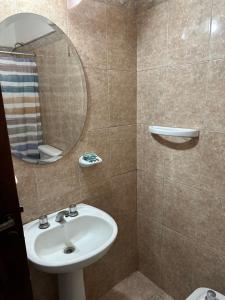 a bathroom with a sink and a mirror at Casa Ciao in Deán Funes