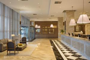 a lobby of a hotel with a reception counter at Windsor Marapendi Hotel in Rio de Janeiro