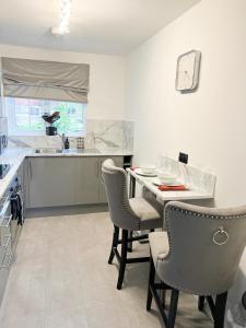 cocina con mesa y sillas en Beautiful apartment in Beckton with Private Entrance and Garden, en Londres