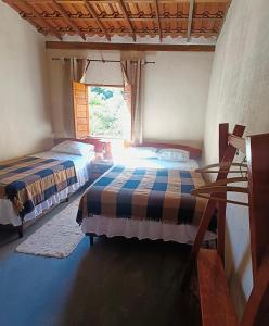 Giường trong phòng chung tại Reserva do Bosque Hospedaria e Natureza
