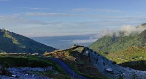 a view of a mountain with a road on it at Penginapan Homestay Sikunir - Bukit Bintang Dusun Musilan in Kejajar