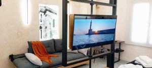 a living room with a tv and a couch at Domus Vivendi in Chania