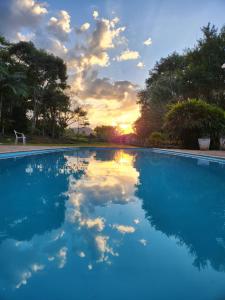 basen z zachodem słońca w tle w obiekcie Hospedaria Santa Luzia w mieście São Bento do Sapucaí