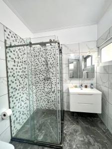 a bathroom with a shower and a sink at Mistral Inn in Himare +47 photos