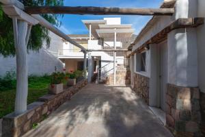 a walkway outside of a house with a building at Casa Bernardina in Tilcara