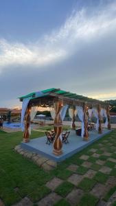 a tent for a wedding with people under it at Casa de Maju in Morros