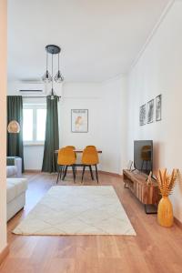 a living room with a table and two chairs at Sunny - Cozy Apartment in Amadora