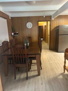 a dining room with a table and chairs and a refrigerator at Huntinaddi Lodge in Halls Gap +12 photos