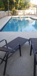 a picnic table next to a swimming pool at South Florida vacation home in Coral Springs
