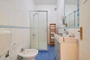 a bathroom with a toilet and a sink and a shower at Sunny - Cozy Apartment in Amadora +35 photos