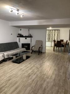 a living room with a couch and a fireplace at Casa din Livadă, Poiana Mărului, Brasov in Poiana Mărului