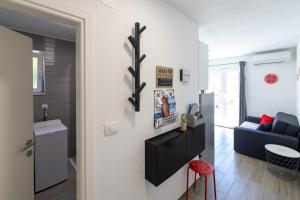a living room with a blue couch and a kitchen at Apartments with a parking space Hvar - 22023 in Hvar