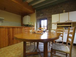 a kitchen with a wooden table in a room at Gîte charmant 5 pers. à Saint-Vert: nature, calme, proche rivières et sites touristiques - FR-1-582-223 in Saint-Vert