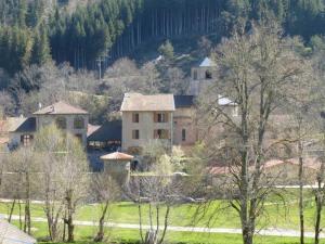 a group of buildings in a field with trees at Gîte charmant 5 pers. à Saint-Vert: nature, calme, proche rivières et sites touristiques - FR-1-582-223 in Saint-Vert +3 photos