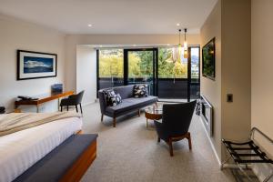 a bedroom with a bed and a living room at Queenstown Park Boutique Hotel in Queenstown