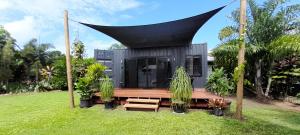 a modern house with a black roof at Ulysses Landing in Kurrimine Beach