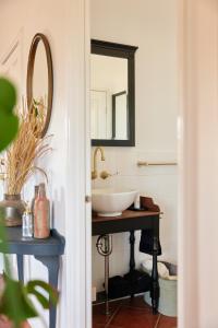 a bathroom with a sink and a mirror at The Caretakers Cottage in Belford