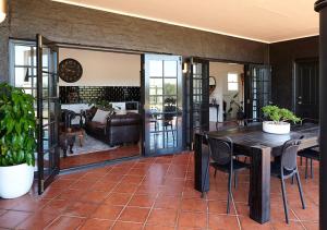 a living room with a table and chairs at The Caretakers Cottage in Belford +7 photos