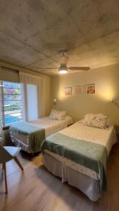 a bedroom with two beds and a window at ALIWENSMA Rauli in San Martín de los Andes +89 photos