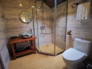 a bathroom with a shower and a toilet and a sink at Yangshuo Yunshe Mountain Guesthouse in Yangshuo