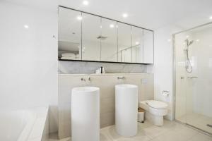 a white bathroom with a toilet and a shower at Oracle 2 1907 in Gold Coast
