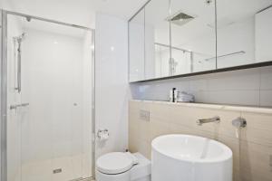 a bathroom with a toilet and a sink and a shower at Oracle 2 1907 in Gold Coast