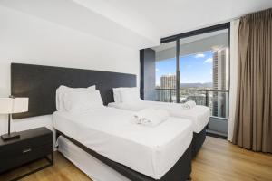 two beds in a hotel room with a large window at Oracle 2 1907 in Gold Coast +37 photos