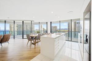 an open kitchen and dining room with views of the city at Oracle 2 1907 in Gold Coast