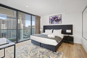 a bedroom with a bed and a large window at Oracle 2 1907 in Gold Coast