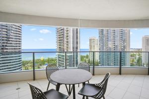 a balcony with a table and chairs and a view of the ocean at Oracle 2 1907 in Gold Coast