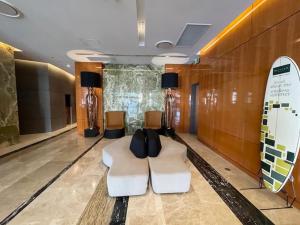 a lobby with a white couch and a surfboard at Oracle 2 1907 in Gold Coast