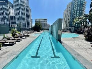 a swimming pool with chaise lounge chairs and buildings at Oracle 2 1907 in Gold Coast