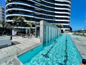 a swimming pool in front of a tall building at Oracle 2 1907 in Gold Coast